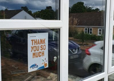 Thank you poster displayed in a window